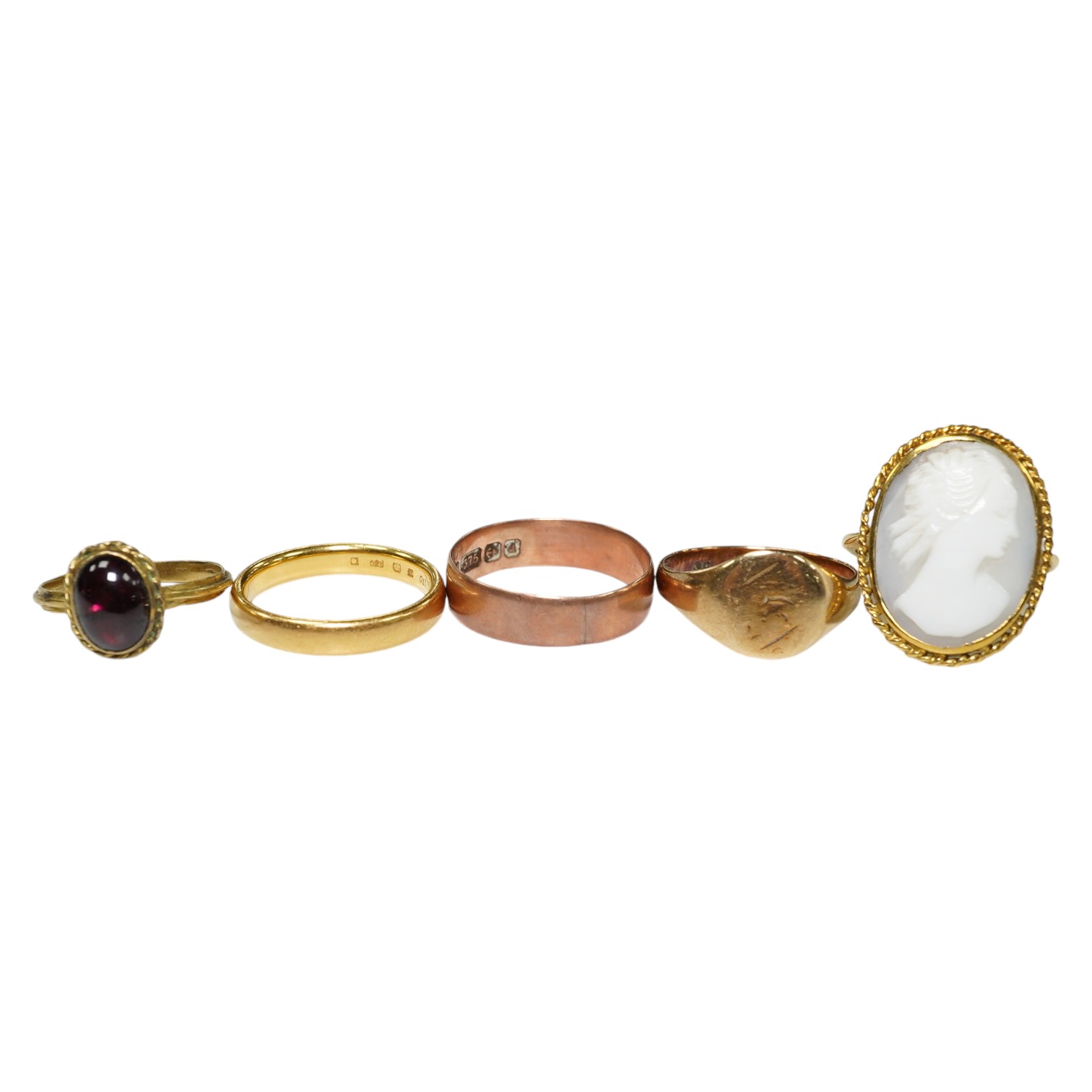 Five assorted rings: a 22ct gold band, size L, 4.2 grams, a 9ct rose gold band, size O, 2.1 grams, a 9ct gold signet ring, size M, 2.1 grams, a red cabochon set yellow metal ring, size I, gross 1.4 grams and a cameo set